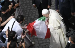 Pope Francis kisses the flag of Lebanon at his general audience on Sept. 2, 2020. Vatican Media.